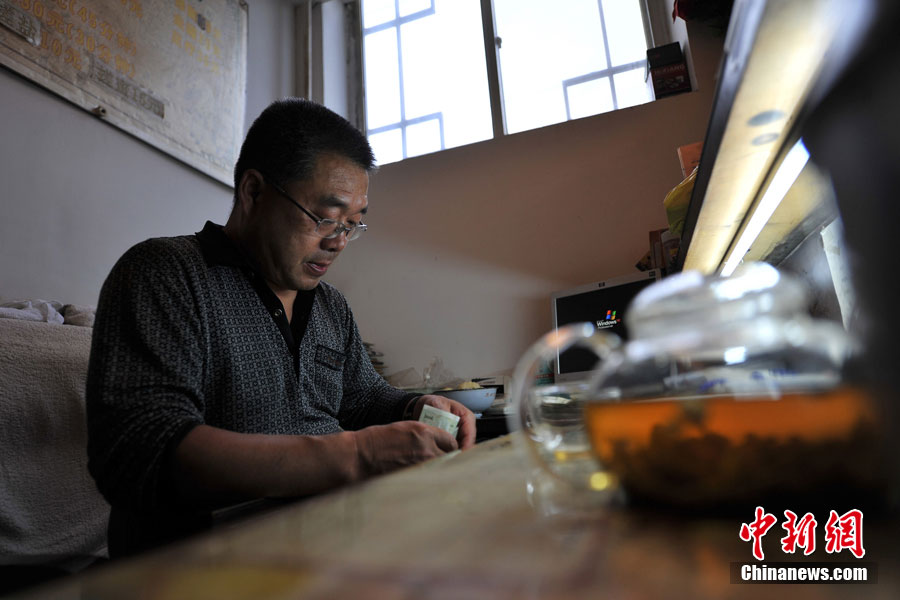 Liu, cajero del ba?o, recuenta los ingresos de la última jornada.