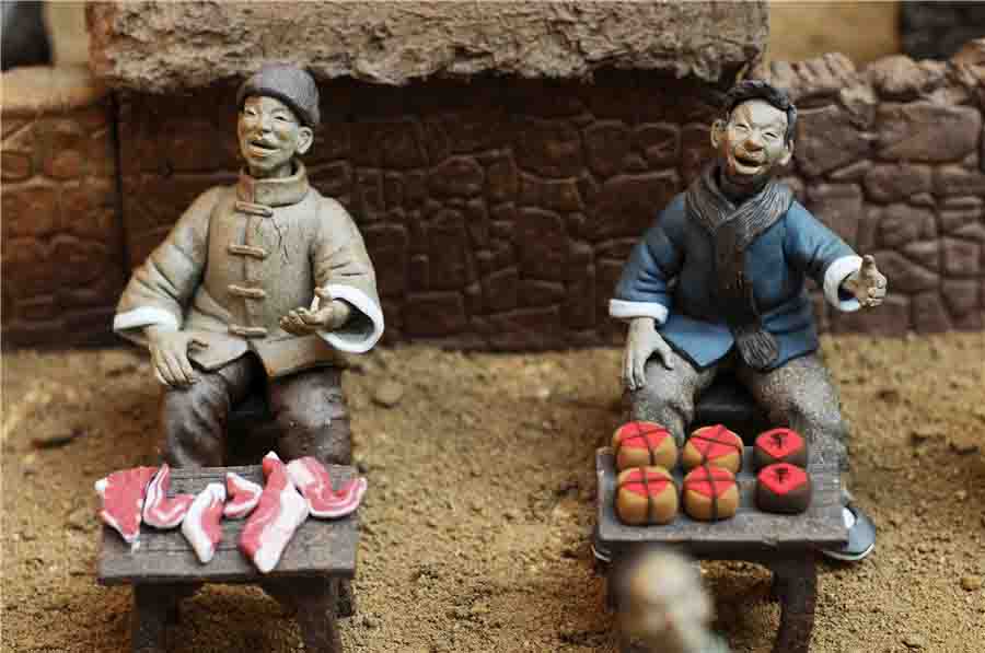 Estatuillas de?unos?vendedores?de?carne?hechas de arcilla.?[Fotografía?por?Wang?Haibin/Asianewsphoto]