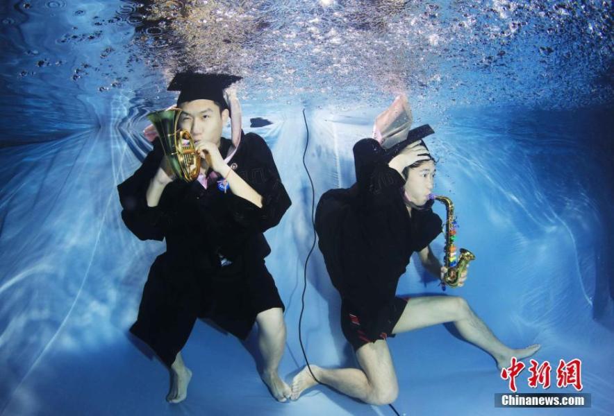 Los estudiantes posan bajo el agua para foto de la graduación