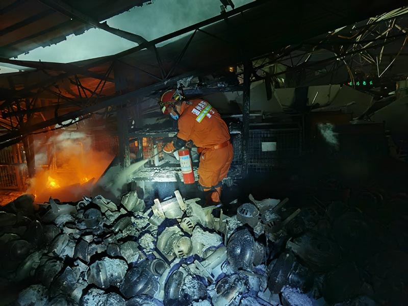 Los bomberos de la Brigada de Bomberos de Wenzhou buscan debajo de los escombros en el lugar de la explosión de un camión cisterna en Zhejiang. [Foto proporcionada a China Daily]