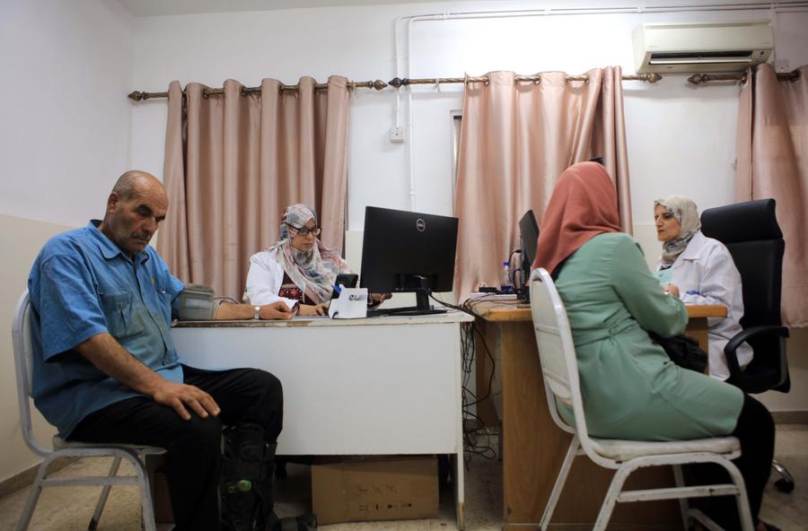 Médicas de la agencia de la ONU para los refugiados palestinos (Unrwa) examinan a pacientes en la clínica del campamento de Jabal el Hussein en Amán, Jordania, el 14 de agosto de 2025. (Xinhua/Mohammad Abu Ghosh)
